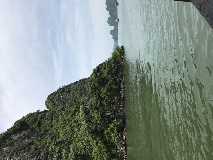 Limestone cliffs over green water in Ha Long Bay